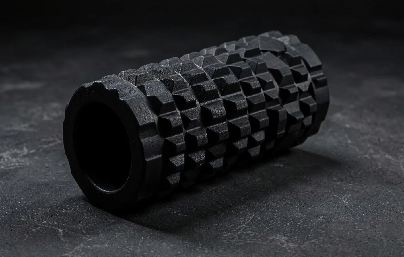 High-density foam roller on dark surface